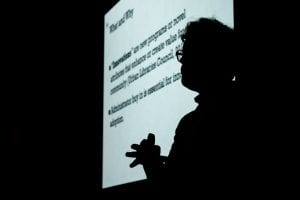 Silhouette of a presenter at the CCI Research Symposium