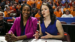 Tamika Catchings and Courtney Lyle wear headsets and broadcast a basketball game.