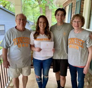 Carolyn Potluck with her son and parents and her UT admission letter