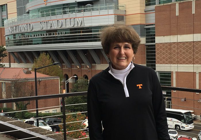 School librarian Patty Williams in a black Tennessee pullover on the third-floor terrace, in front of Neyland Stadium.