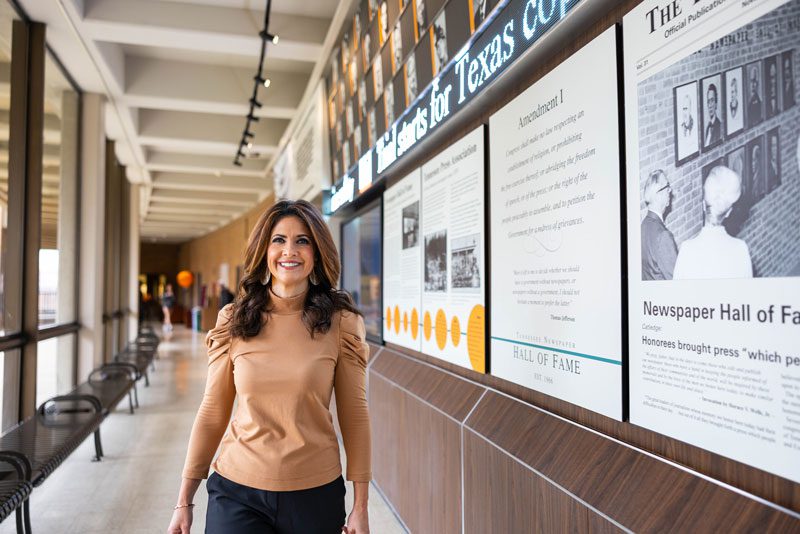 Former WBIR-TV news anchor Beth Haynes walks down the hallway on the third floor of the Communication and Information building, next to the news ticker.