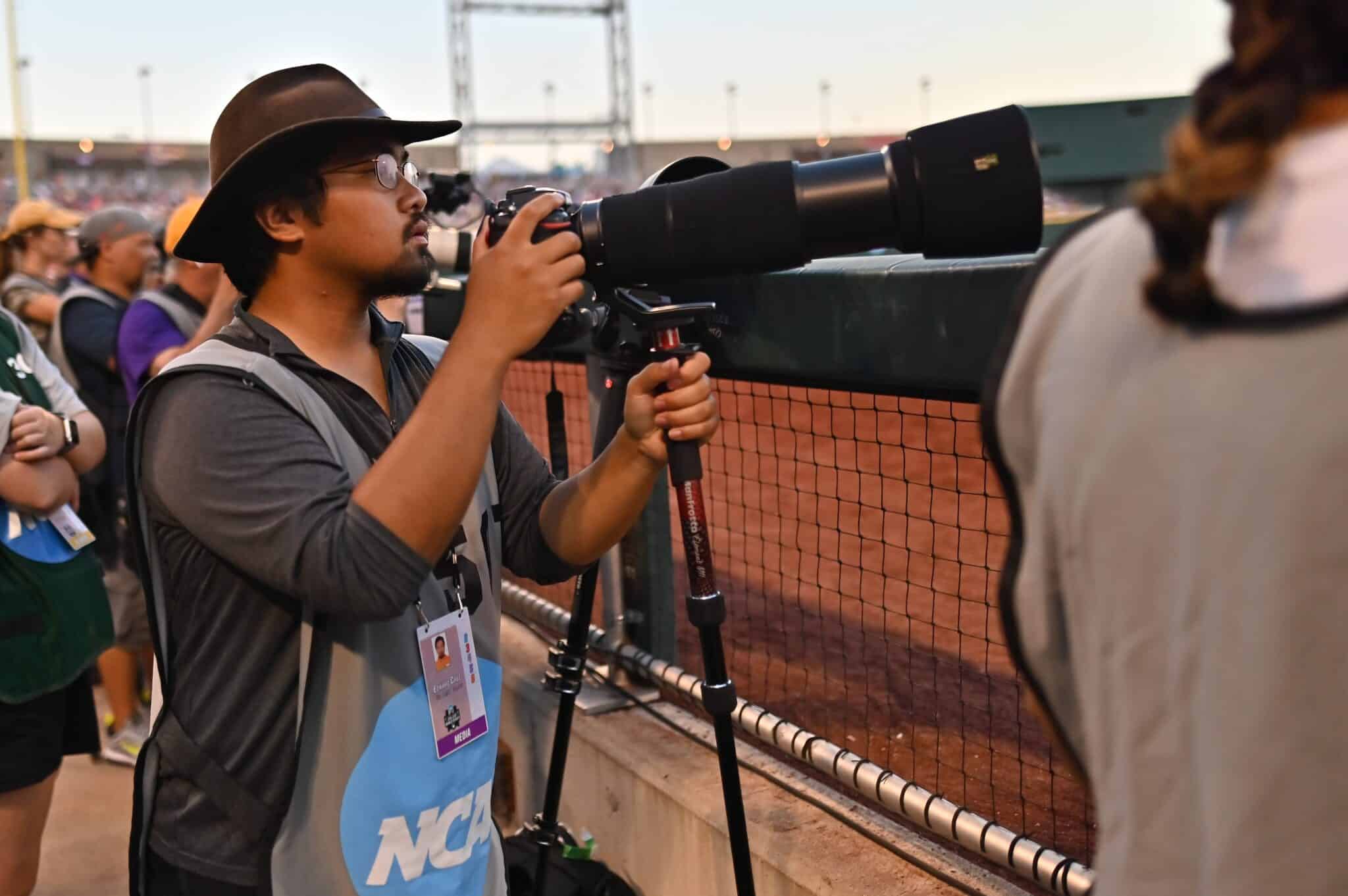 student taking photos with a camera.