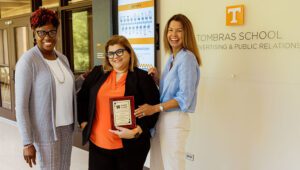 From left: Dionne George, Maria de Moya, and Beth Foster hold up the Diversity Action Alliance for the Best Internal DEI Initiative award.