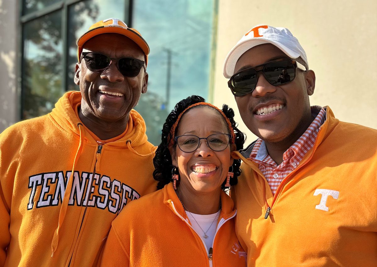 Jamil Price with his parents, all in orange Vol gear.