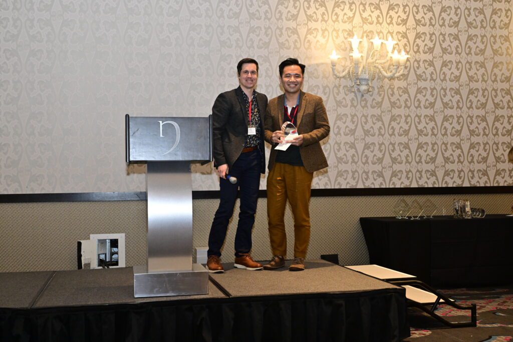 Assistant Professor Minjie Li (right) winning the Best Diversity, Equity, and Inclusion Conference Paper award