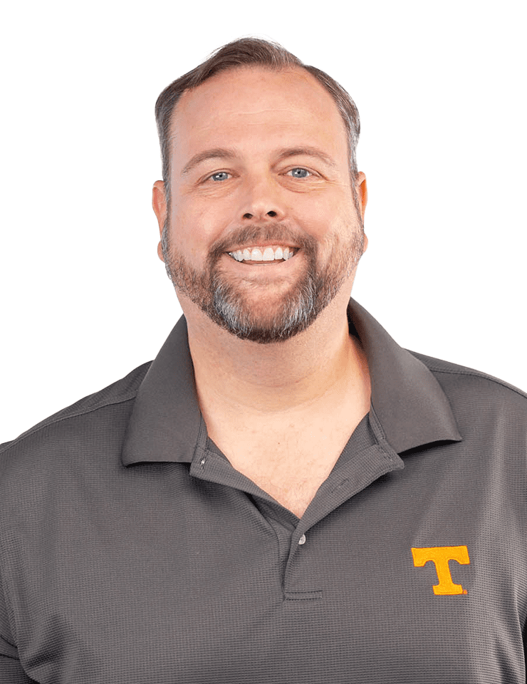 A headshot of Wade Bishop wearing a Smokey gray polo shirt with a small orange Power T on  it.