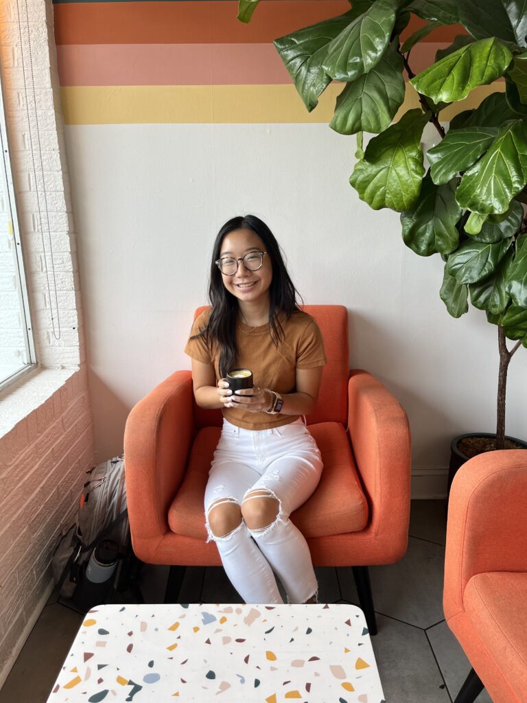 Sarah Yeow sitting in a chair at a coffee shop