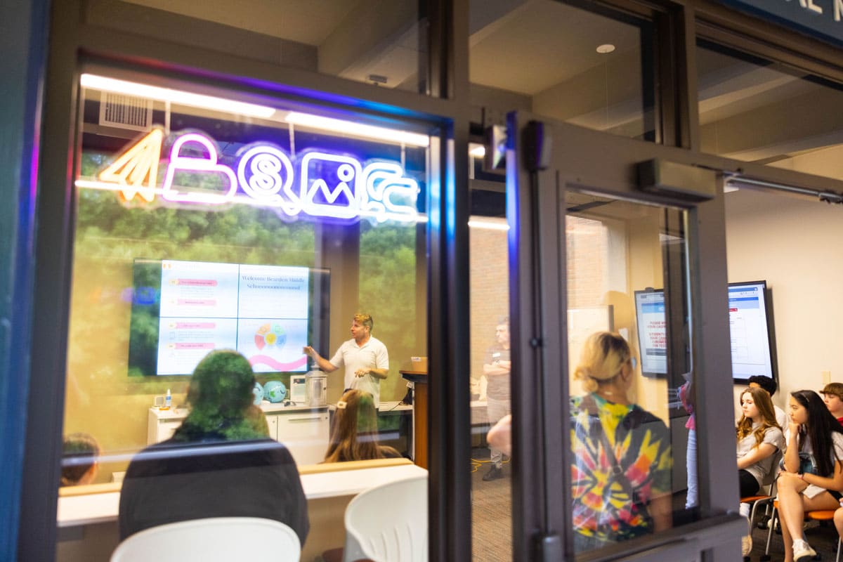 High school students learn about data and audience analytics in the Adam Brown Social Media Command Center.