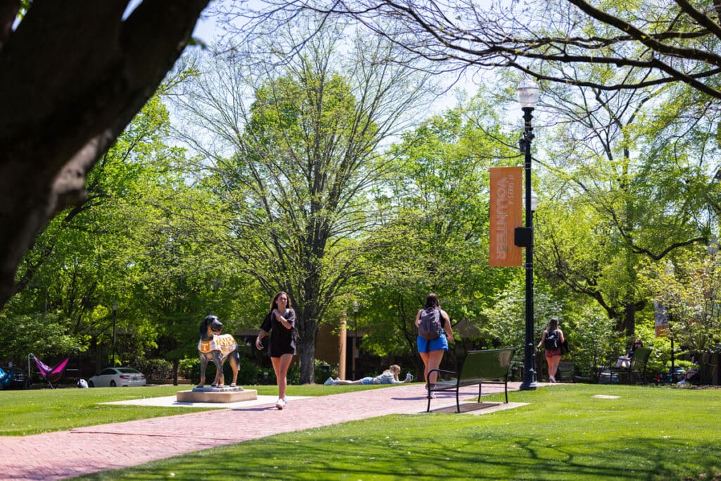 a view of one of the paths in Circle Park that passes through the grass and statues of Smokey the dog.