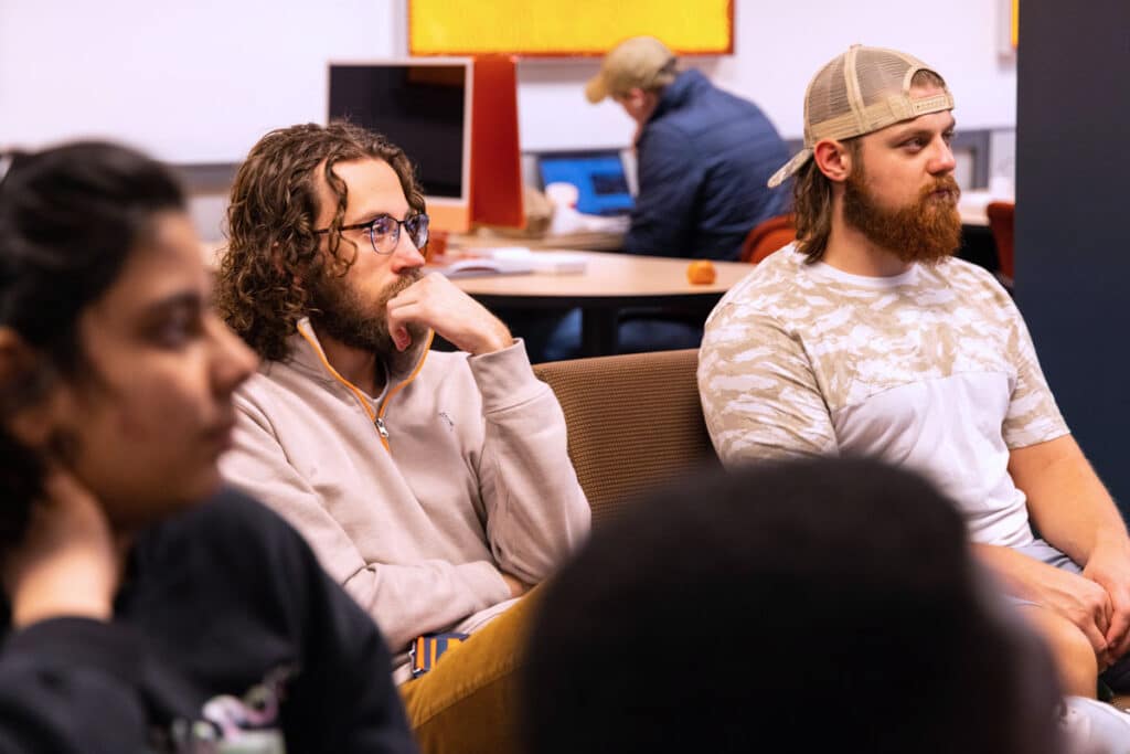 Students sit in CCI's Scripps Lab and listen while getting a lesson on lighting for video.