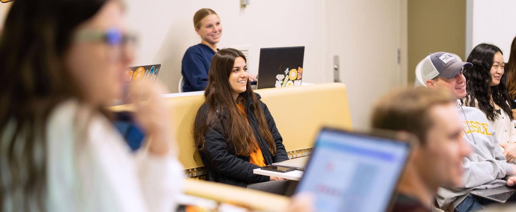 Students listen and smile during a class in the Adam Brown Social Media Center.