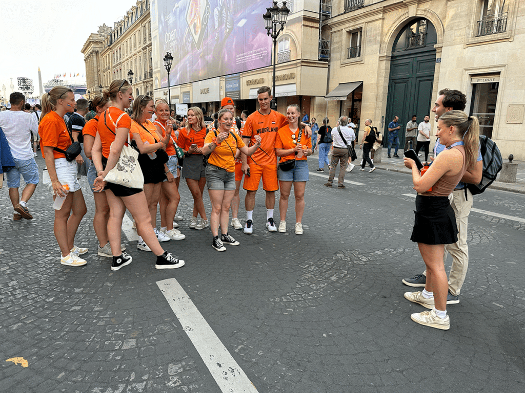 School of Journalism and Media students Lillian Van Alsburg and Griffin Hadley interview fans from the Netherlands at the 2024 Paralympic Games in Paris, France.