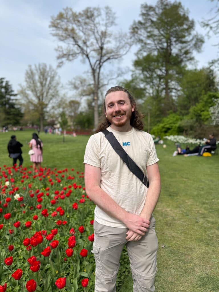 Joseph Edgerton next to flowers