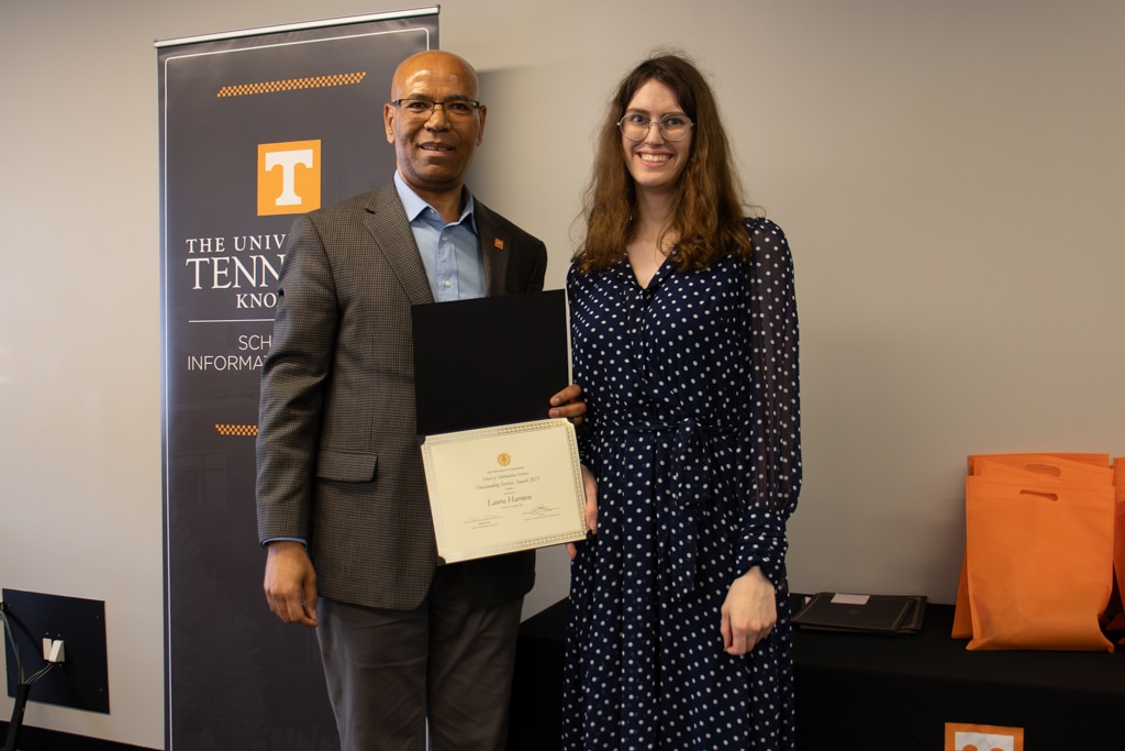 Laura Harmon, right, accepts the Outstanding Service Award (On-Campus) from SIS Director Abebe Rorissa.