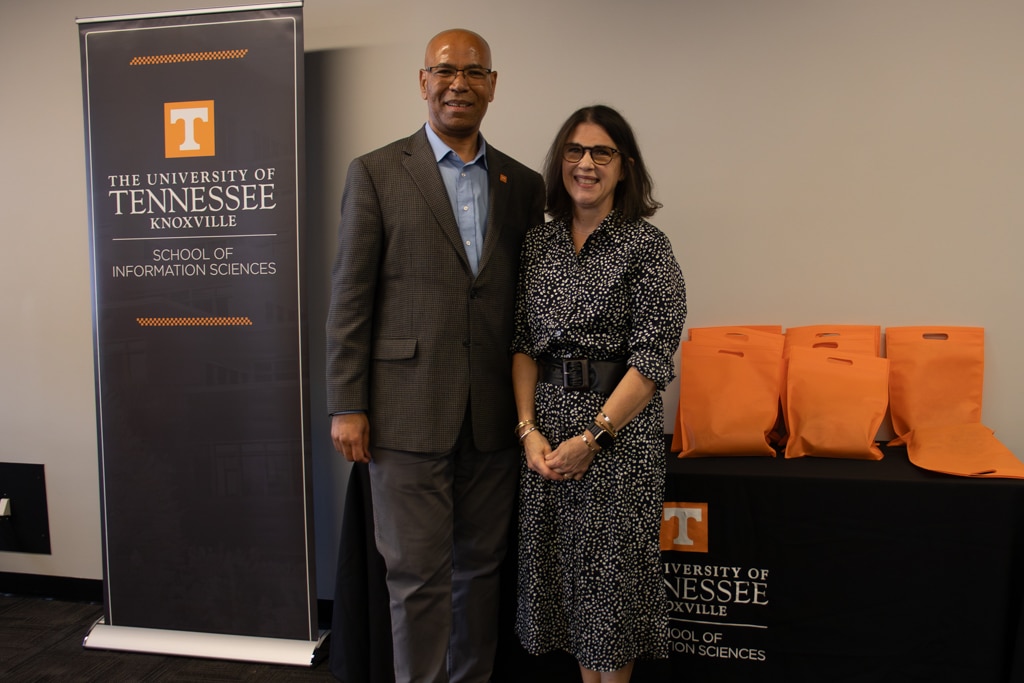 Associate Professor Rachel Fleming-May, on the right, accepts the Bonnie Carroll and Roy Cooper Faculty Enrichment Award (Tenured) from SIS Director Abebe Rorissa.