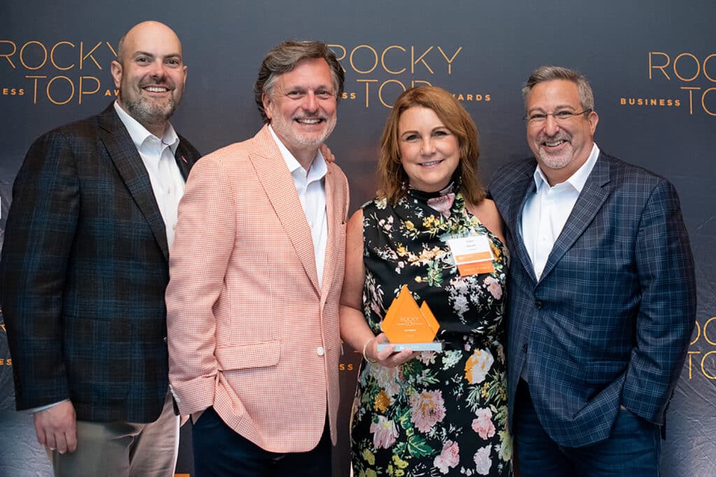 Cindy Brewer poses with her Rocky Top Business Award alongside Spencer Broocks, VP of Finance, Kevin Brewer, Co-Founder and Partner, Cindy Brewer, Co-Founder and Partner, and David Kenyon, Senior Vice President of Production.