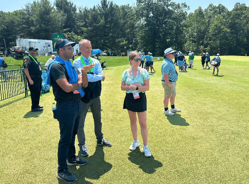 Golf Writers’ Association of America (GWAA) inaugural Herbert V. Kohler Jr./GWAA Scholarship recipients Aman Misra (left) and Amanda Vogt (right) on the range with Golf Channel broadcaster Rex Hoggard (middle) during the 2025 U.S. Open.