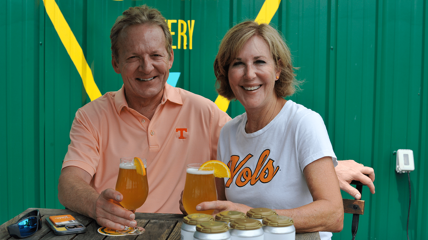 Sharon and Mark Oldham poses with a Wit & Orange beer at their newest establishment Peaceful Side Brewery and Taproom in downtown Maryville.