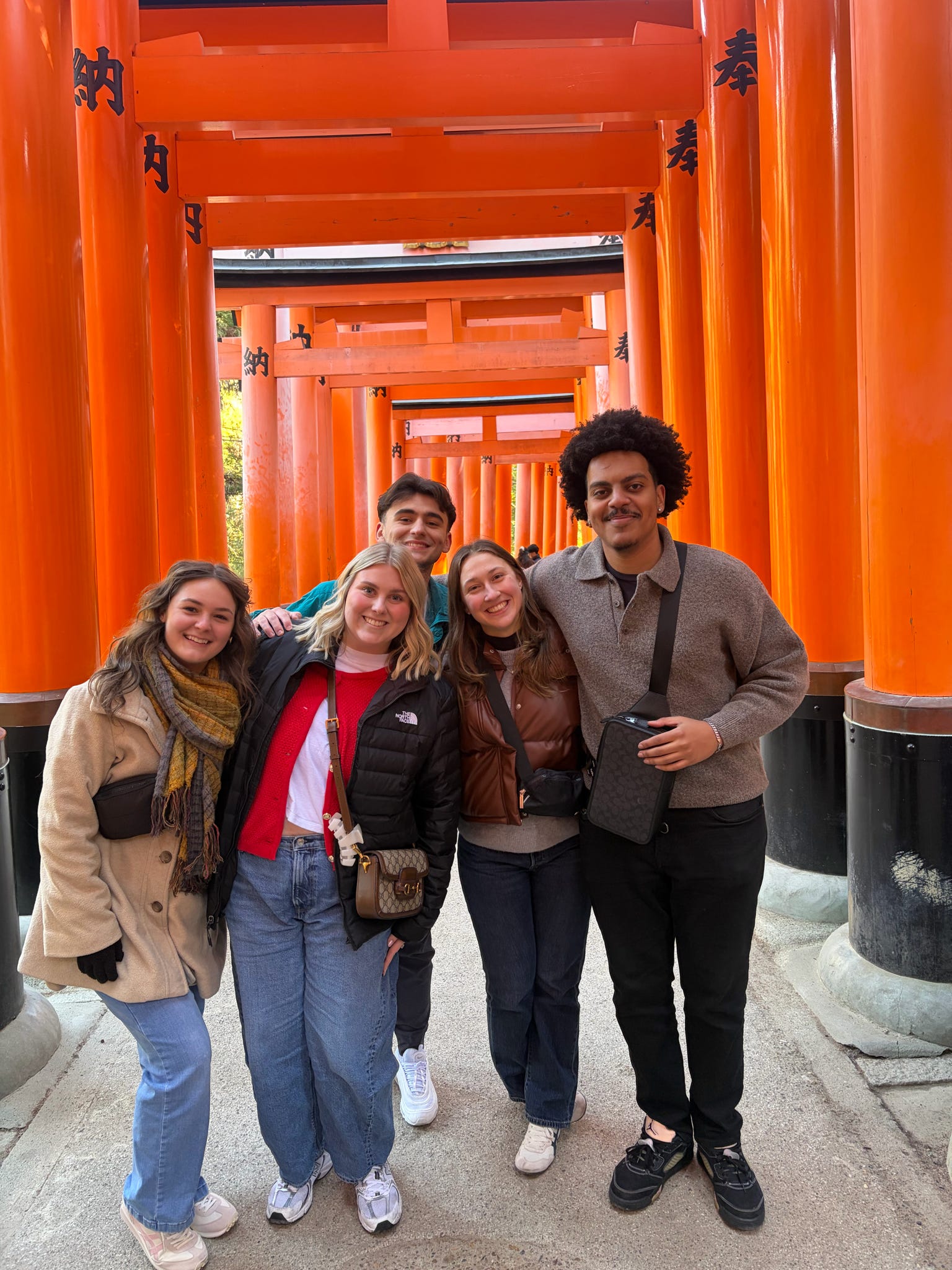 Five Wilson Academy students posing for a group photo as they tour the Senbon Torii (Thousand Torii Gates) in Kyoto, Japan, during the academy's recent trip to Japan in January 2026.