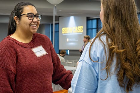 Students connecting with Alumni at the Tombras School Showcase