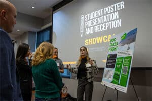 Students presenting their poster boards at the Tombras School Showcase