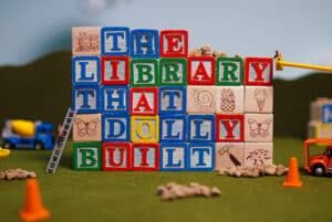 Children's toy blocks spell out "The Library that Dolly Built"